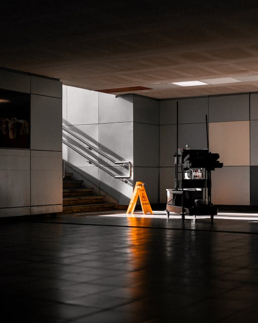 Photograph of Westminster Station entrance in Westminster, London, showing the iconic red Underground sign hanging from a black metal frame. Below the sign is a black rectangular board displaying 'Wes